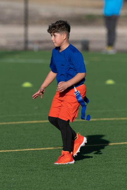 istock Young Athletic Boy Playing Flag Football 1299123643