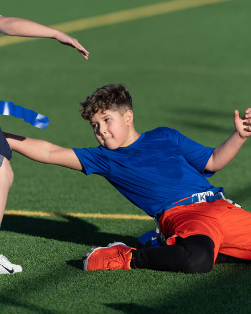 istock Young Athletic Boy Playing Flag Football 1299123689