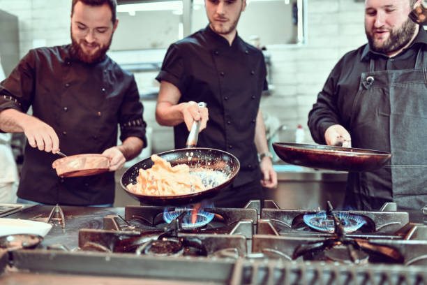 istock Chefs In Kitchen Competing To Make The Perfect Dinner 1299124202