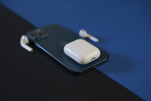 Rome, Italy, January 26, 2021: Luxury Presentation of AirPods and iPhone 12 Pro max Pacific Blue