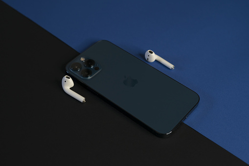Rome, Italy, January 26, 2021: Luxury Presentation of AirPods and iPhone 12 Pro max Pacific Blue