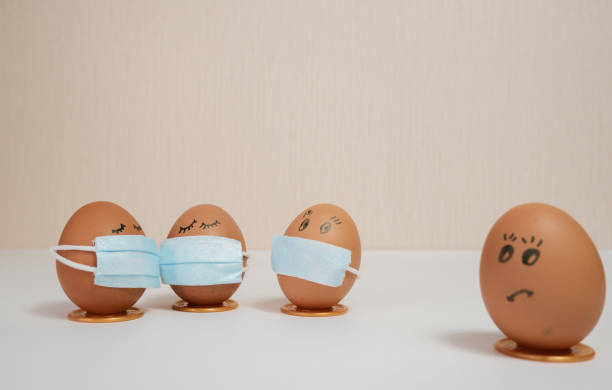 istock Eggs put on face mask - quarantine concept during Easter. Easter eggs in a medical mask. Self-isolation concept. 1299124255