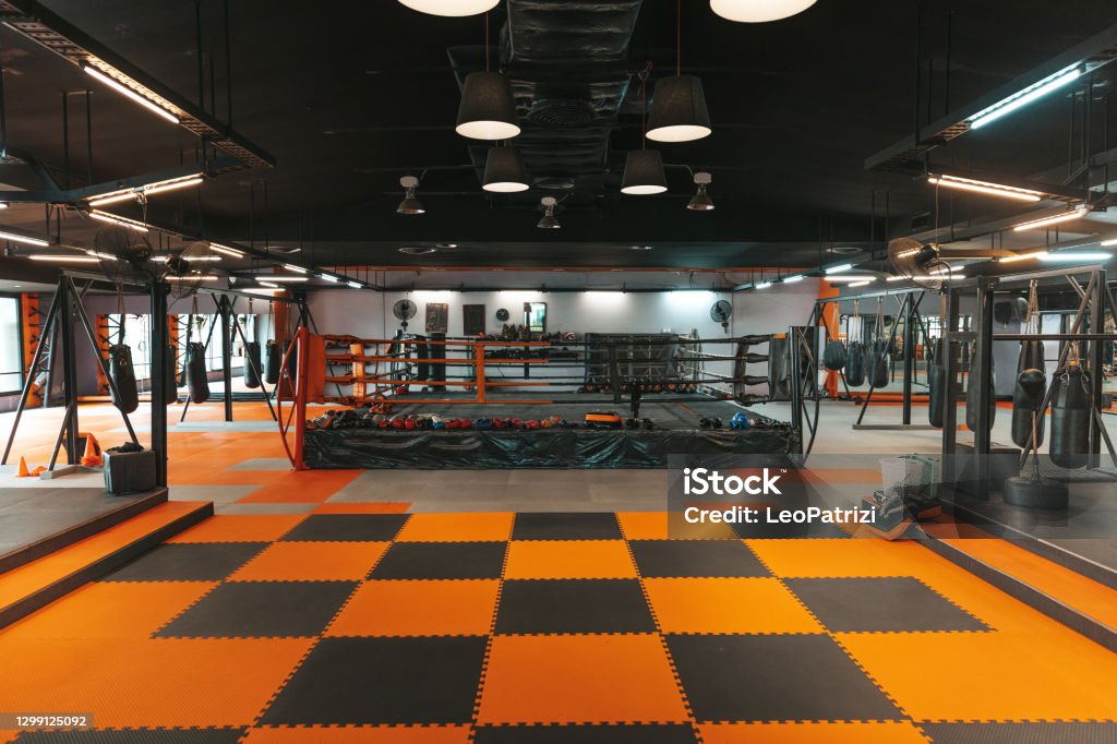 Boxing club Modern thai boxing gym in Thailand, boxing ring and punching bags visible in the image. Gym Stock Photo