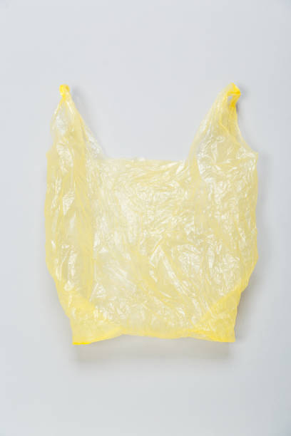 istock used yellow plastic disposable bag on gray background 1299125280