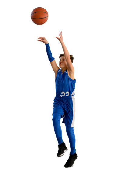 istock Young Athletic Boy Playing Basketball 1299125506