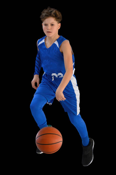 istock Young Athletic Boy Playing Basketball 1299125517