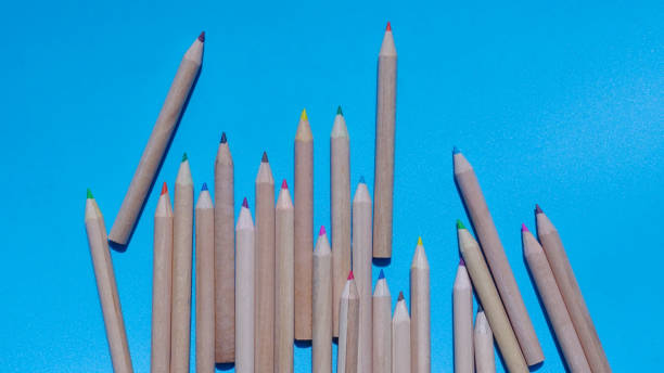 istock Colored wooden pencils on blue background 1299126809