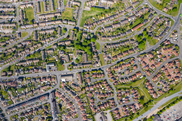 Top down aerial photo of the British town of Middleton in Leeds West Yorkshire showing typical suburban housing estates with rows of houses, taken on a bright sunny day using a drone. stock photo