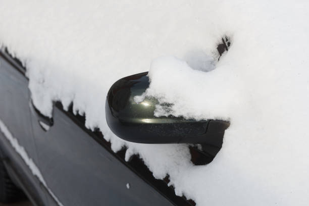 istock The mirror of the car is covered with snow. 1299129599