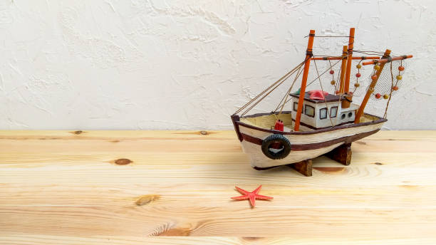 istock Fishing boat starfish with copy space on wooden background. 1299130553