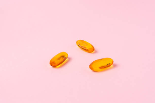 istock Fish oil on light pink background. 1299131844