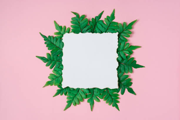 istock Creative layout made of green leaves with paper card note. Nature concept. Flat lay. 1299132813