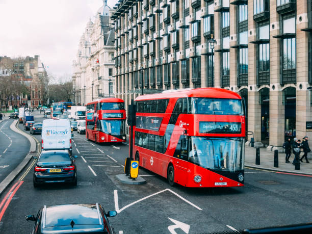 red double-decker bus in london city center street traffic - big ben london england uk double decker bus imagens e fotografias de stock