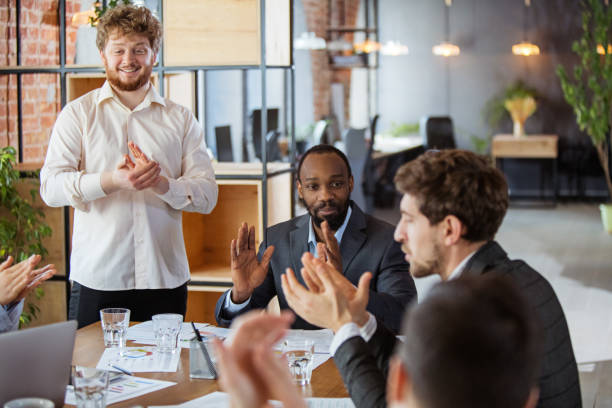 istock Diverse group of co-workers having casual discussion in office. Executives during friendly discussion, month reporting, creative meeting 1299132959