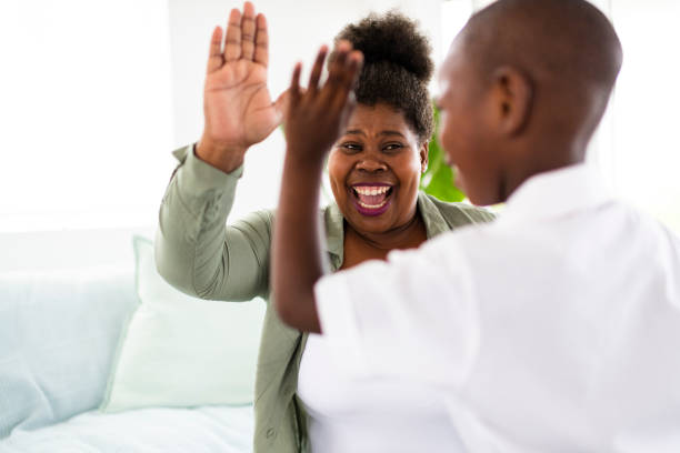 istock African mother and son celebrating with a high five 1299133382