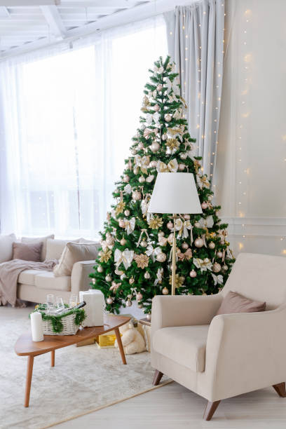 istock Luxury rich expensive apartment interior in light colors. Stylish contemporary minimalistic design. Full of sun light. A lot of space decorated with Christmas tree 1299134433