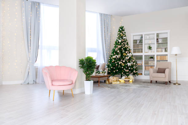 istock Luxury rich expensive apartment interior in light colors. Stylish contemporary minimalistic design. Full of sun light. A lot of space decorated with Christmas tree 1299134565