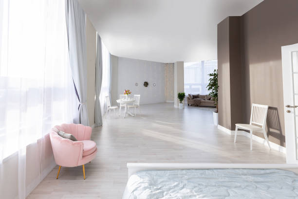 istock Stylish modern bedroom with a minimalistic design in a luxurious rich, expensive interior of an open-plan apartment in light colors. 1299134858