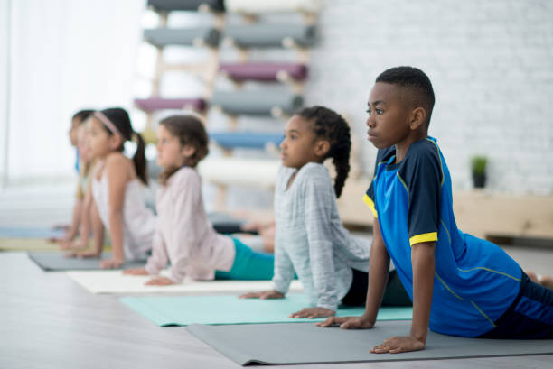 istock Children doing yoga together 1299135555