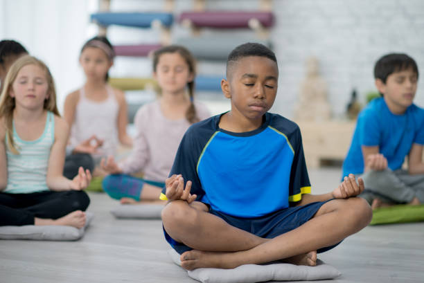 istock Children meditating together in yoga class 1299135567