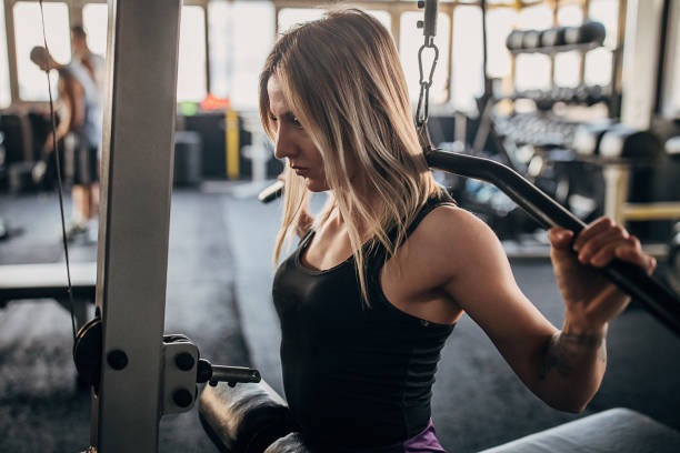 istock Fit woman training on exercise machine in gym 1299136961