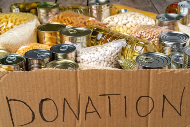 istock Food donations on the table. Text Donation. 1299137044