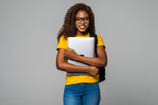 istock African woman high school student typing on portable isolated on white background 1299137067