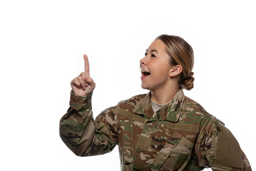 Happy female soldier pointing up.