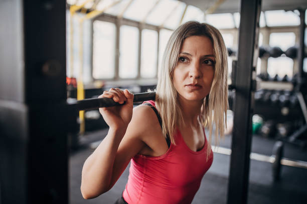 istock Fit woman exercising with weights in gym 1299137999