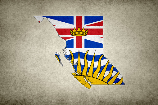 Grunge map of the province of British Columbia (Canada) with its flag printed within its border on an old paper.