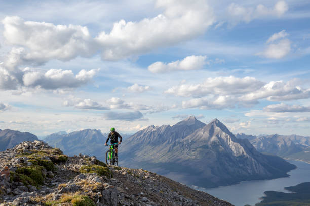istock Mountain biker rides along mountain ridge in the morning 1299138976