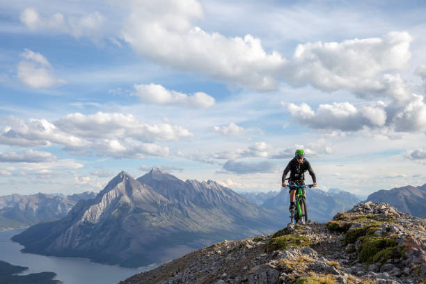 istock Mountain biker rides along mountain ridge in the morning 1299139234