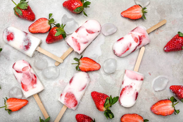 istock Homemade popsicles with strawberries, ice lollies on sticks, top view, flat lay 1299139385