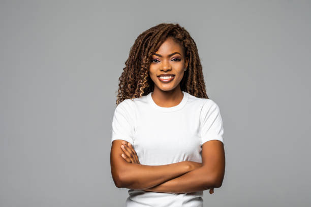 istock Joyful African American student keeps hands crossed isolated over white background. 1299139497