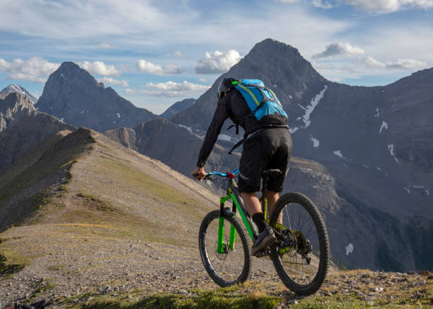 istock Mountain biker rides along mountain ridge in the morning 1299139658