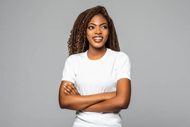 istock Joyful African American student keeps hands crossed isolated over white background. 1299140161