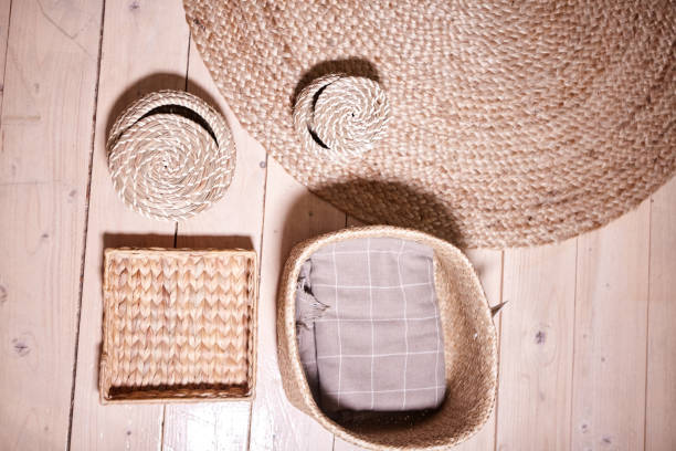 istock Straw wicker basket and white natural cotton fabric. Marie Kondo's storage boxes, containers and baskets with different sizes and shapes for tidying up wardrobe. KonMari method organizer boxes set. 1299140873