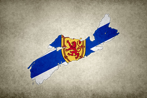 Grunge map of the province of Nova Scotia (Canada) with its flag printed within its border on an old paper.