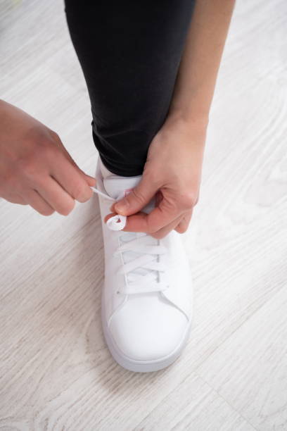 istock Sportsman tying white sneaker 1299141269