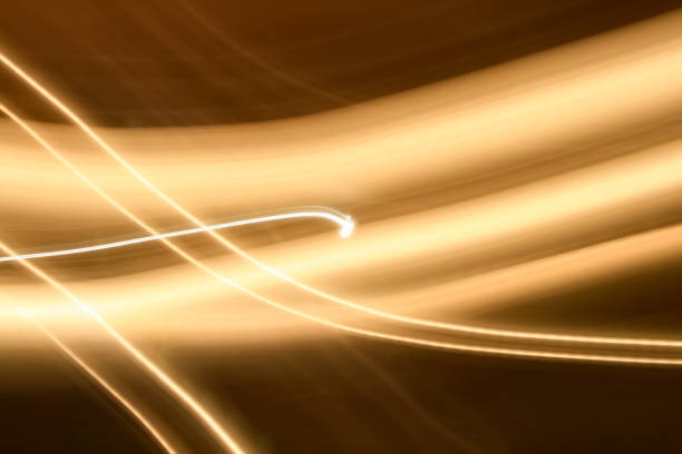 istock Light and stripes, glow abstract effect. Vivid gold ribbon on golden background 1299141289