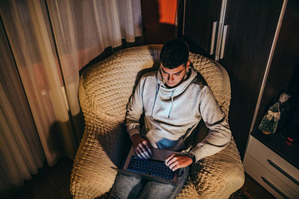 istock Male Student learns online during COVID-19 pandemic 1299141460