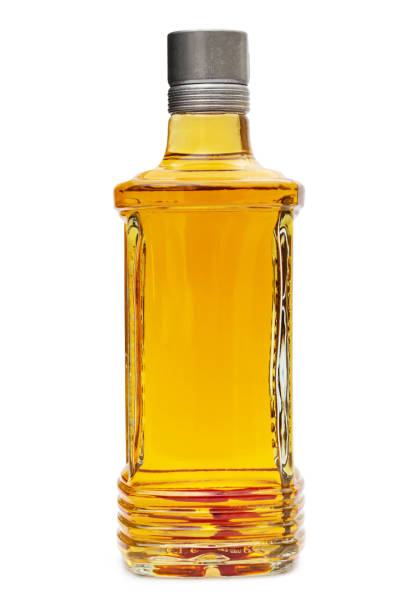 istock Bottle of vodka with chilli pepper isolated on white. 1299143959