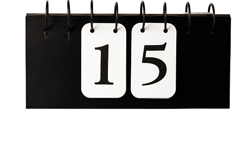 Close up view of calendar with selected date 15 isolated on white background.