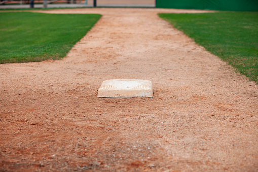 Selective focus low angle view of a baseball infield looking toward home from third base