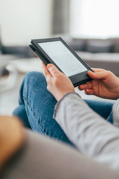 istock Woman Reading E-Book at Home 1299147132
