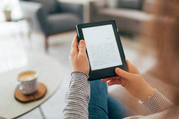 istock Woman Reading E-Book at Home 1299147794