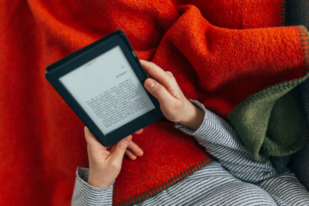 istock Woman Reading E-Book at Home 1299147795