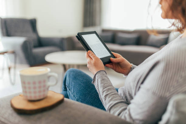 istock Woman Reading E-Book at Home 1299147893