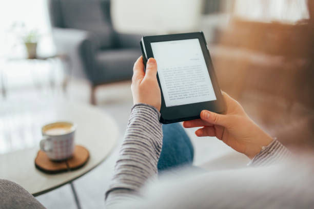 istock Woman Reading E-Book at Home 1299147895