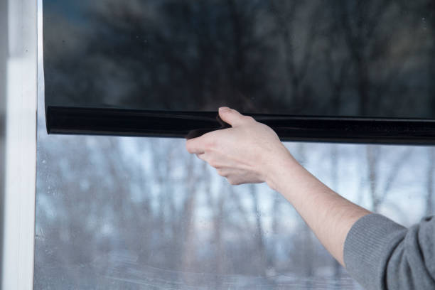 istock Installation of window film in the office. 1299149462